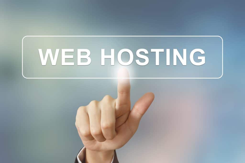 business hand clicking web hosting button on blurred background